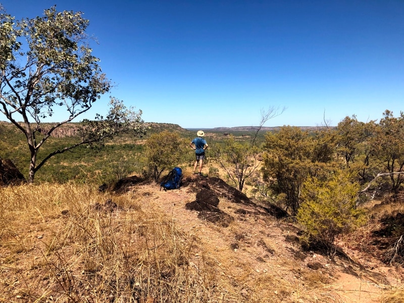 Man looking out to view of desert. The Jatbula Trail 