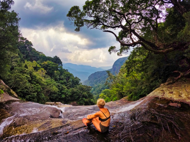 Sitting on the edge of Duwili Ella Waterfall, The Knuckles Mountain Range, Sri Lanka