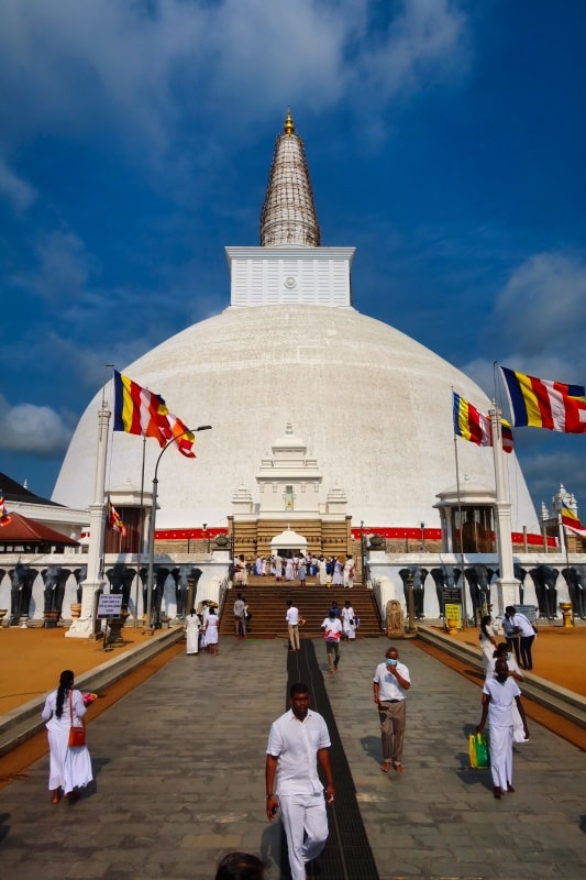 Pilgrims walking through a temple, one of the best things to do in Anuradhapura 