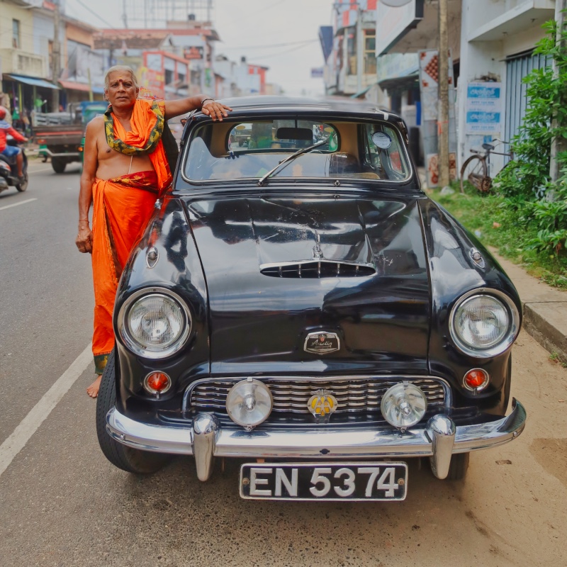 Man posing next to car in Jaffna. 
