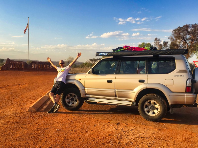 Car in front of the Welcome to Alice Springs sign 