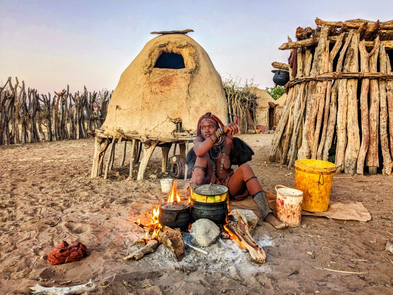 A Himba woman preparing dinner 