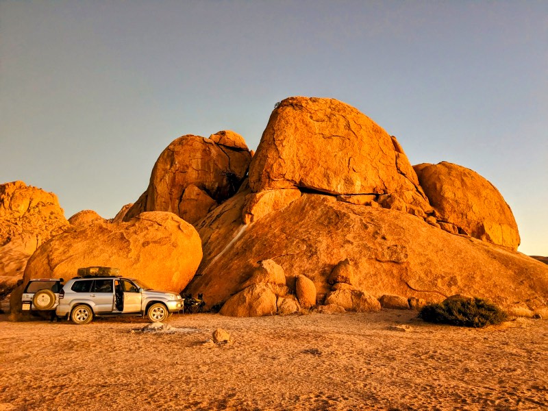 Our car parked near some big rocks just outside Spitzkoppe