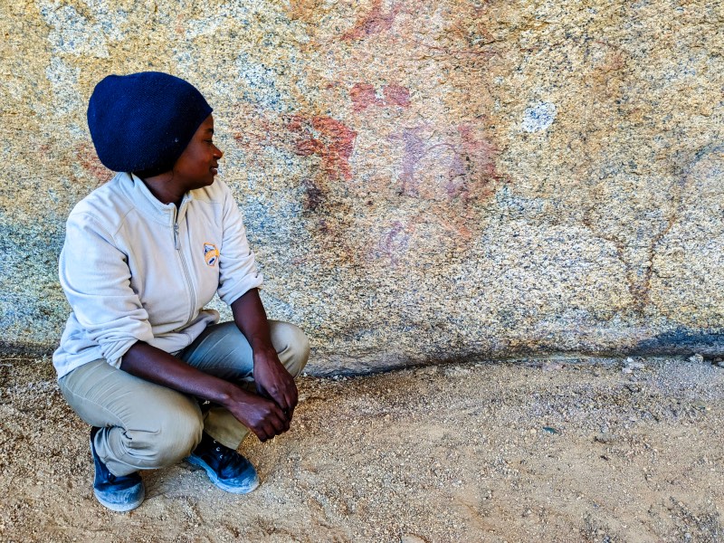 Our guide Jennifer looking at a rock painting at while hiking at Spitzkoppe