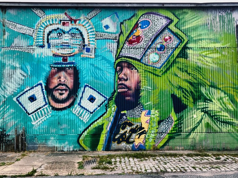 A mural of two men in The Baywater - New Orleans Cool Neighborhoods